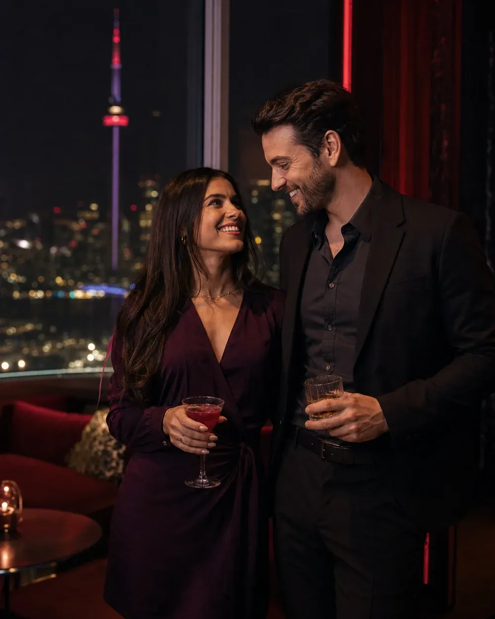 Stylish adult couple enjoying a rooftop lounge overlooking the Toronto skyline